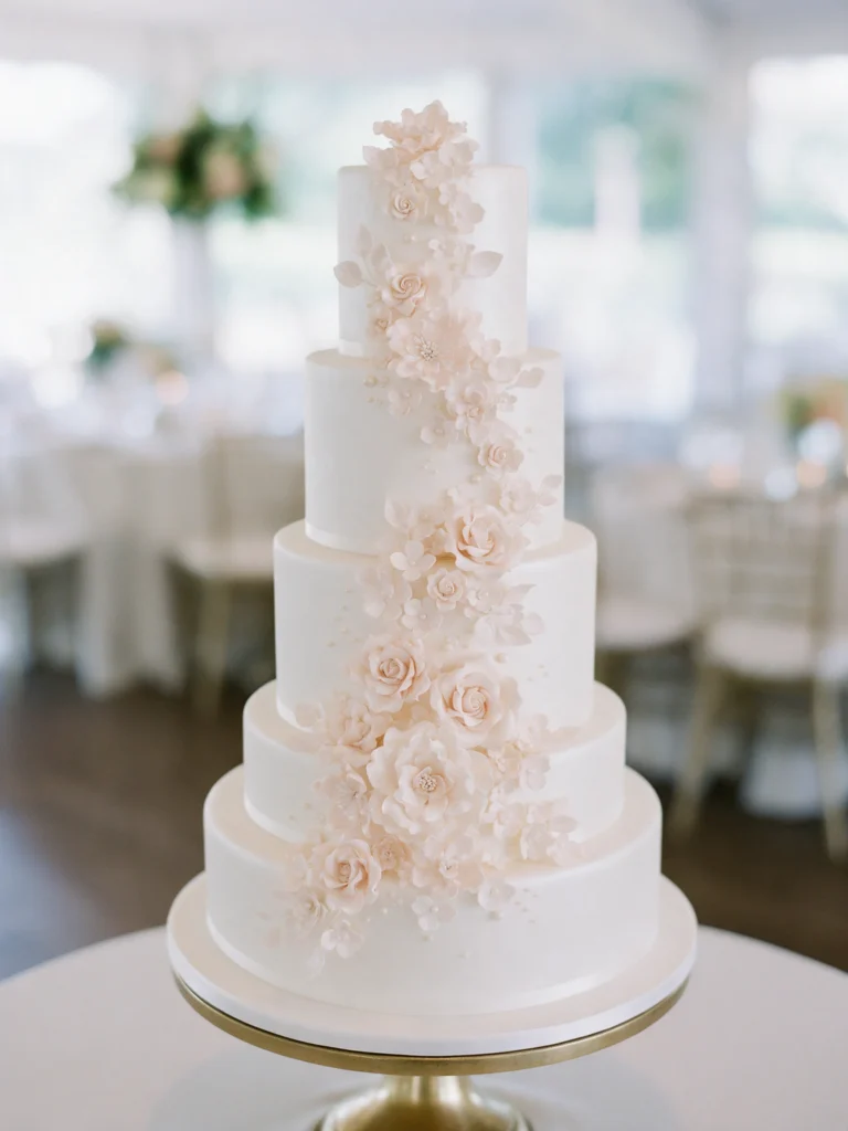 White wedding cake with blush sugar flowers